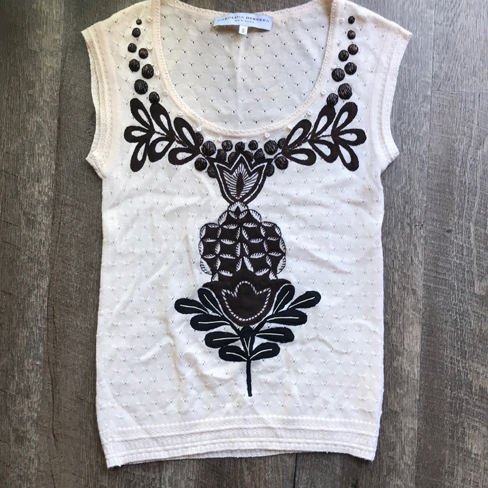 Knit Carolina Herrera sweater with appliqué.